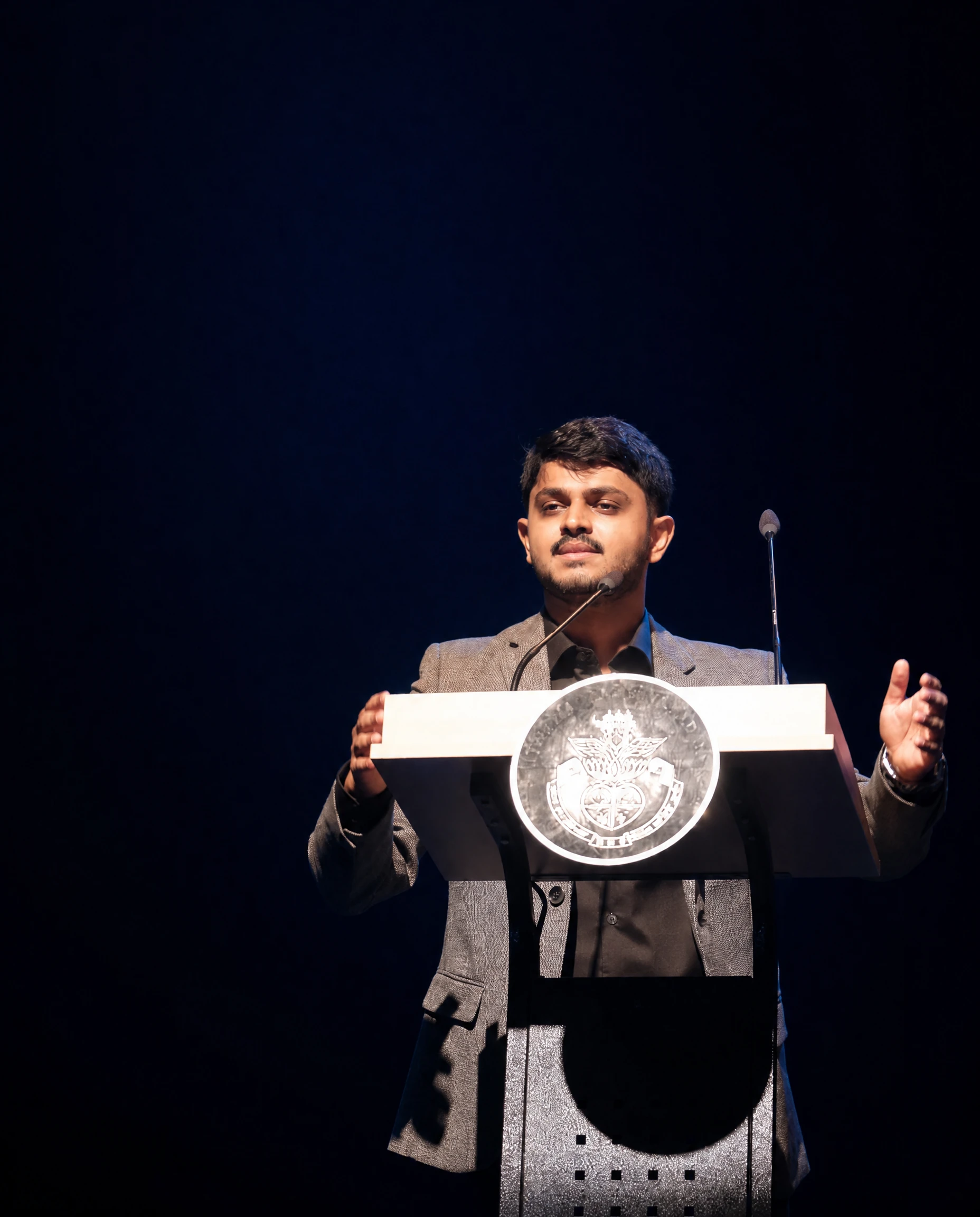 Anirudh Dalmia delivering a guest-of-honour address on stage